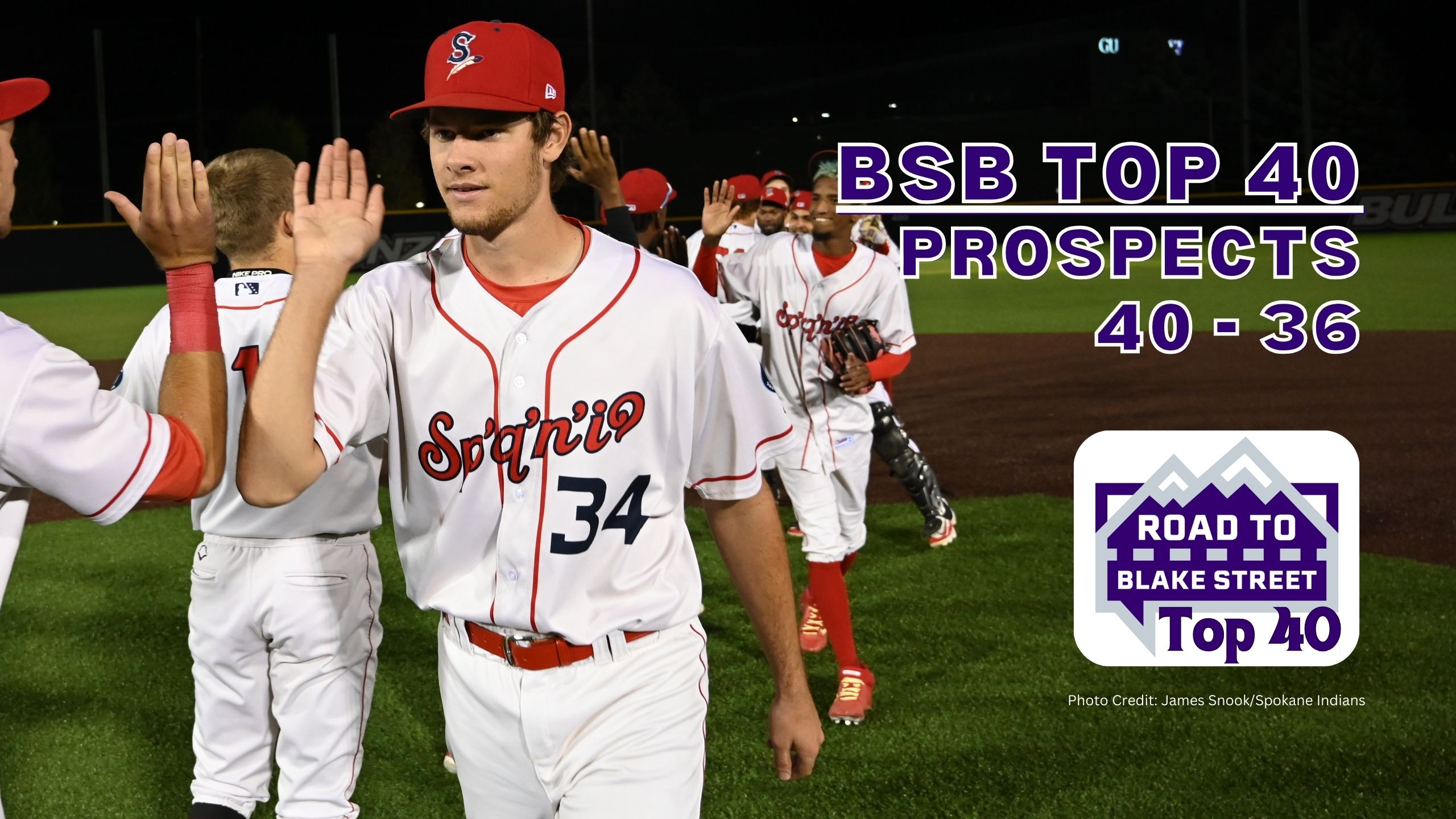 Reliever Cade Denton giving high fives for Spokane Indians